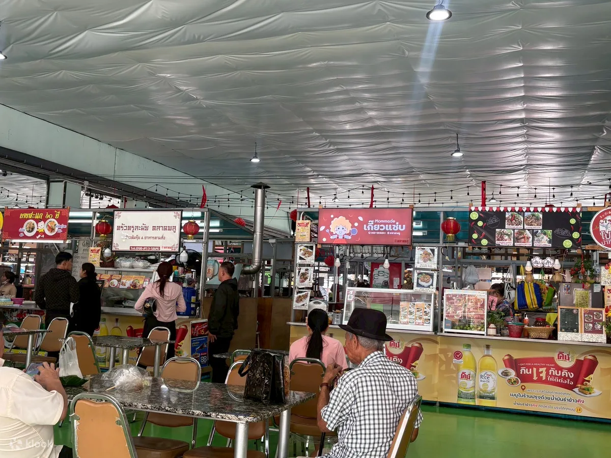 Stalls and Thai-Chinese signage inside Talat Phlu market
