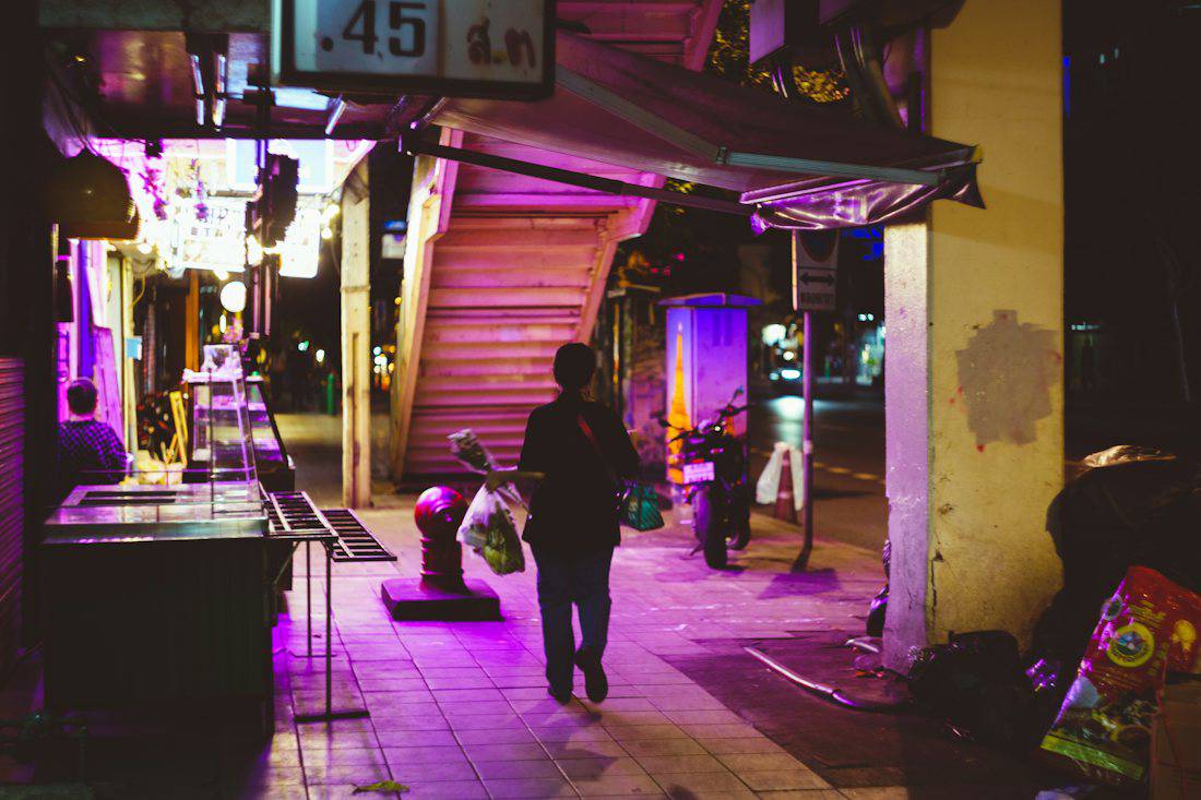 Neon-lit side street in Bangkok at night