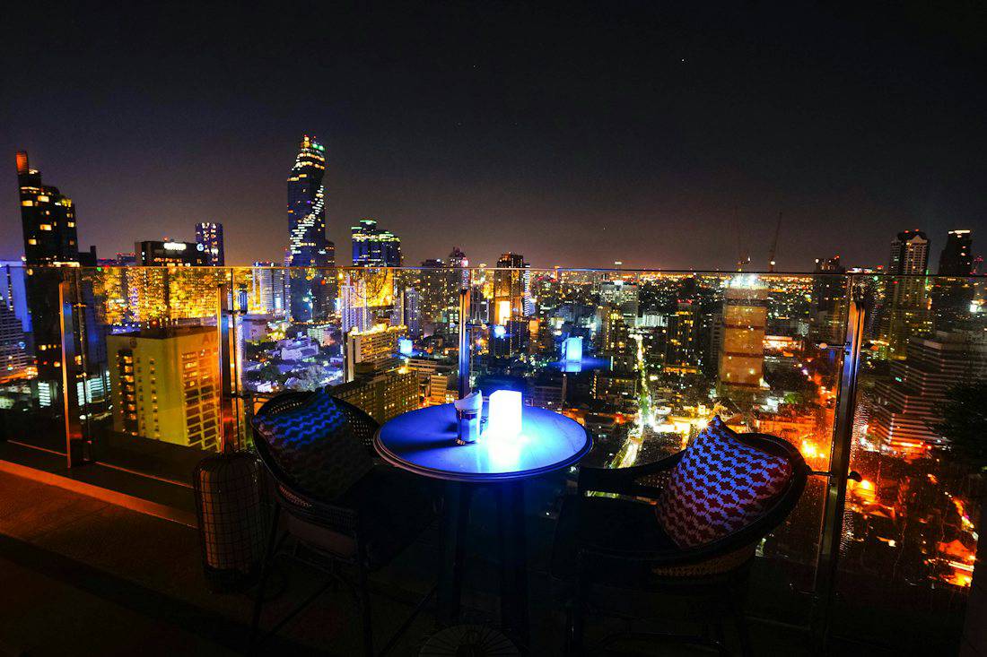 Rooftop lounge with the Bangkok skyline at night