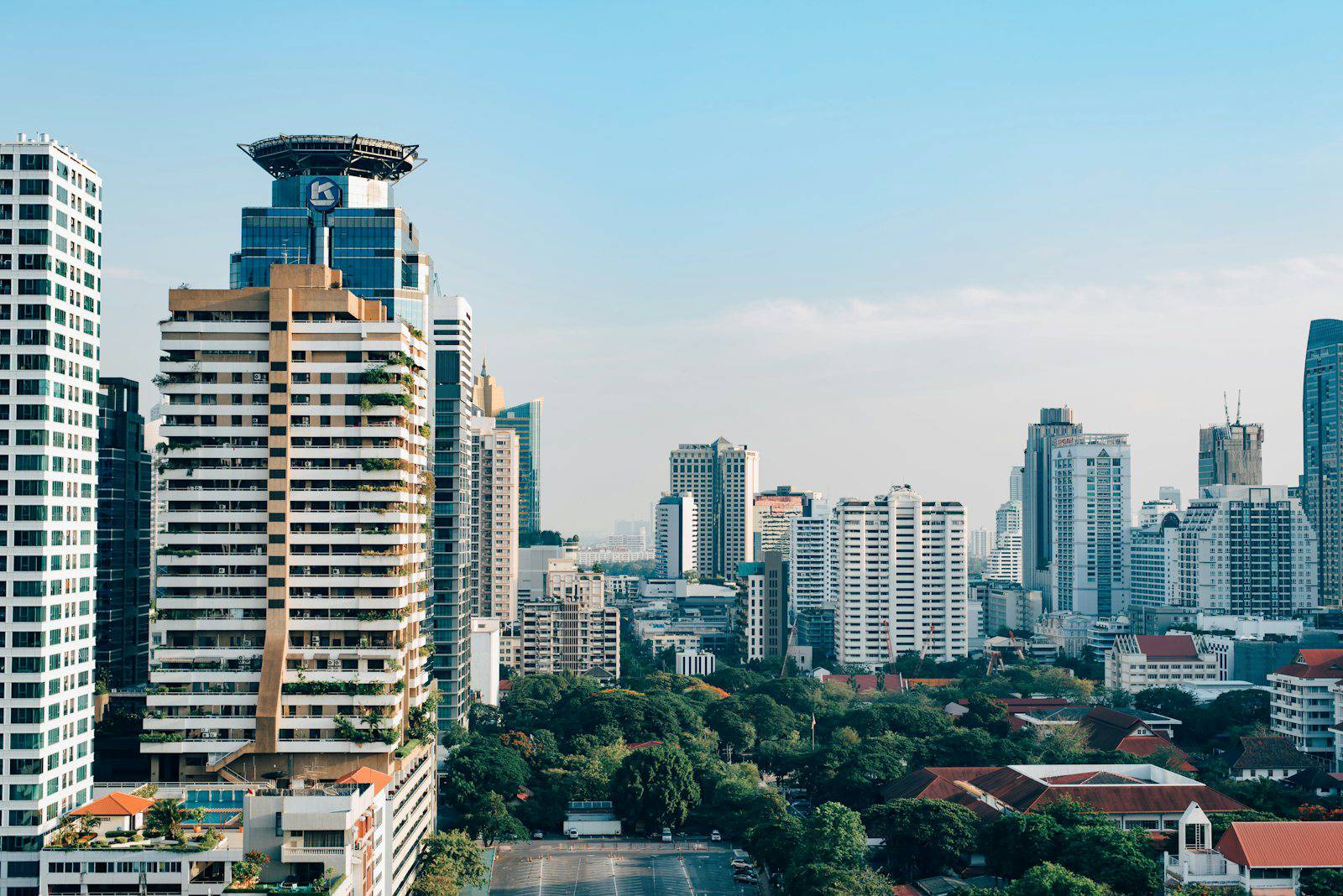 Bangkok condo towers above a leafy residential neighborhood