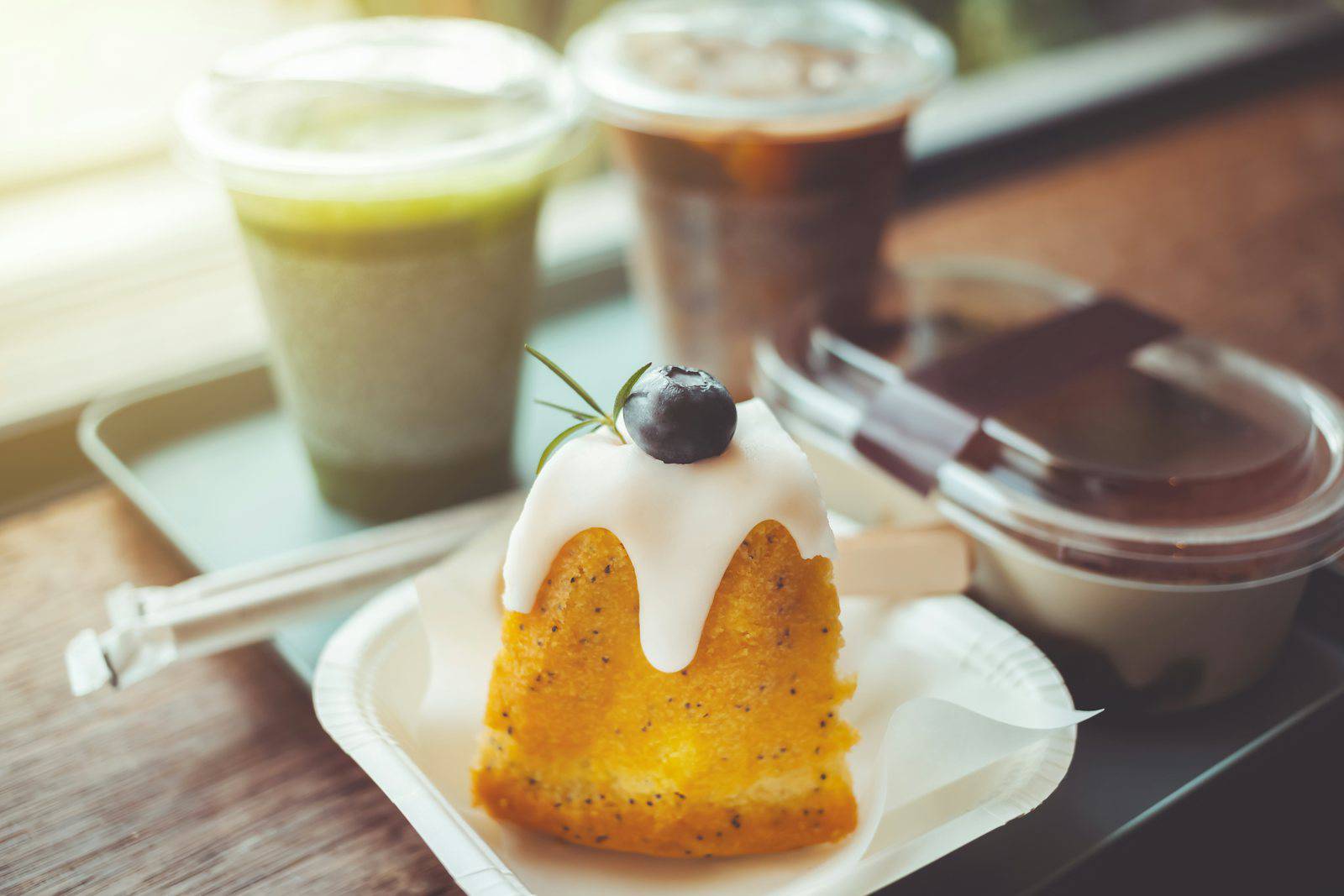 A pastry with a cherry on top of it on a plate