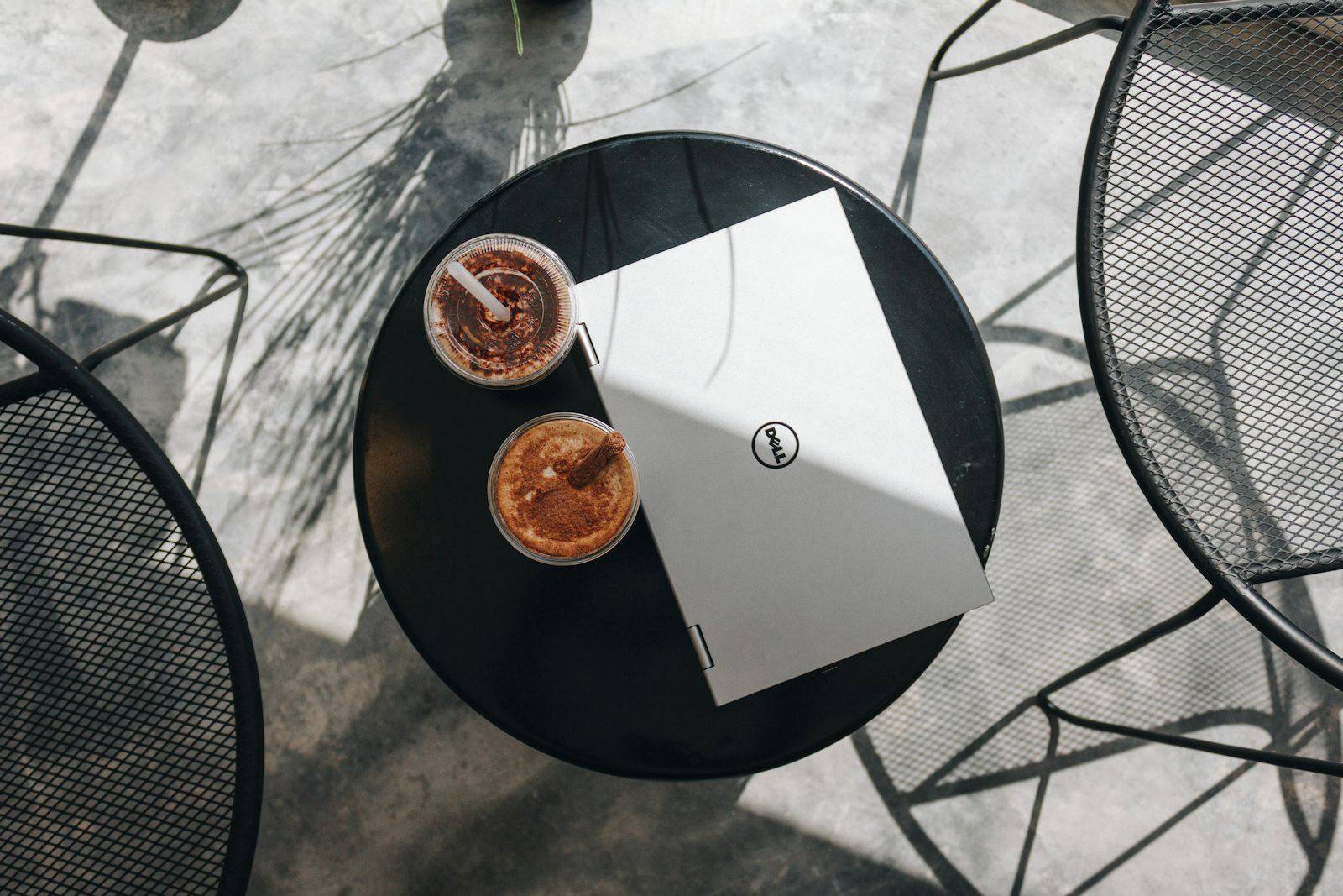 Laptop workspace set up on a cafe table