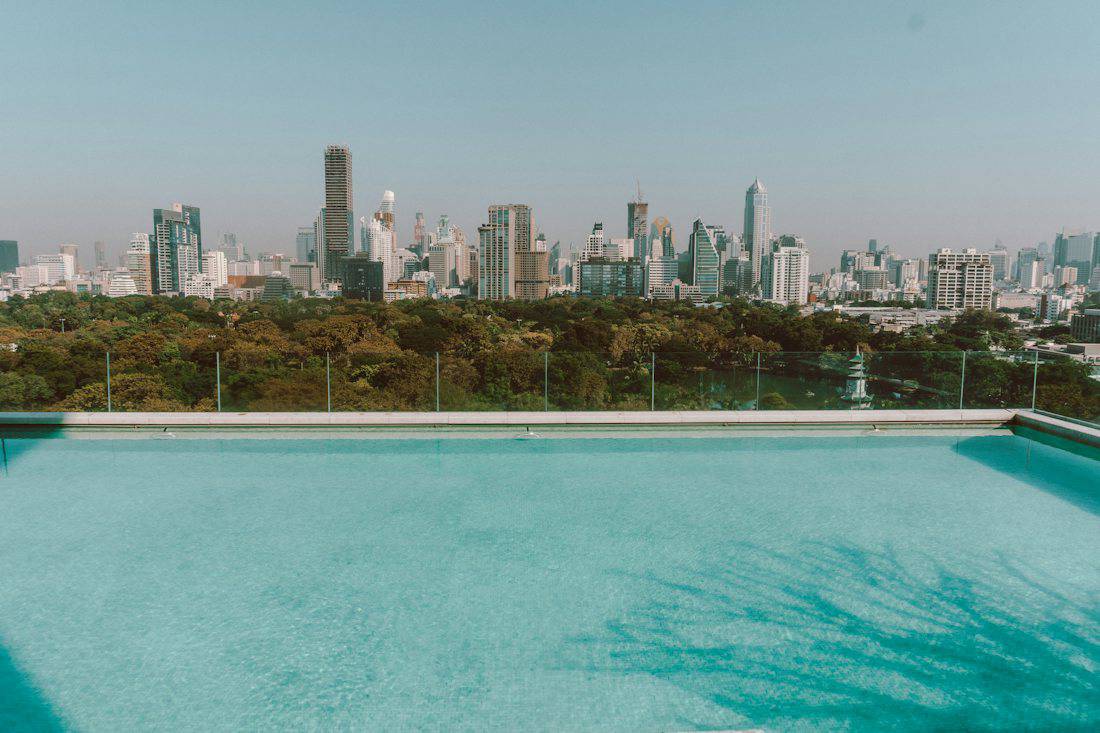 Hotel swimming pool with a view of the Bangkok skyline
