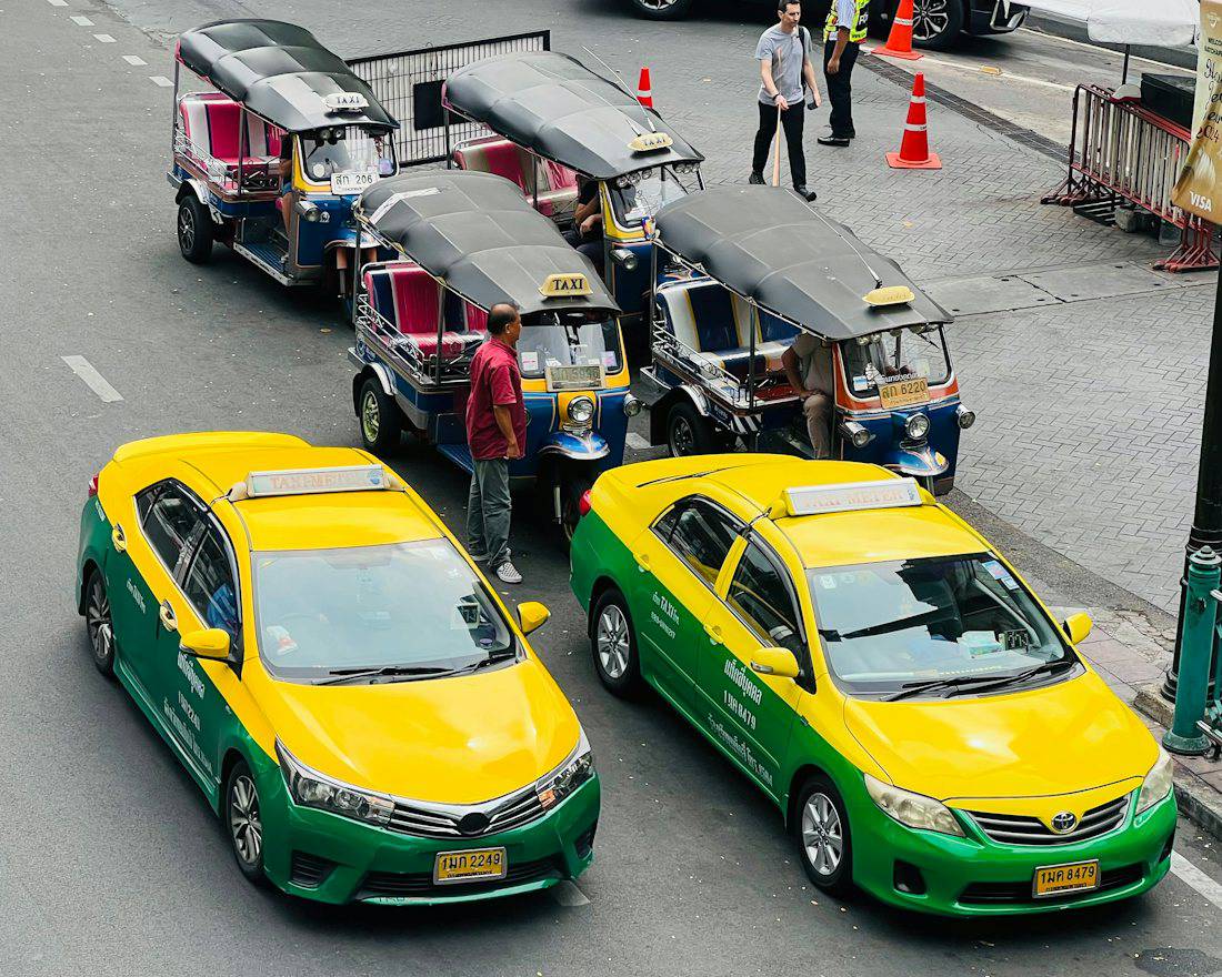 Bangkok taxis and tuk tuks waiting for passengers