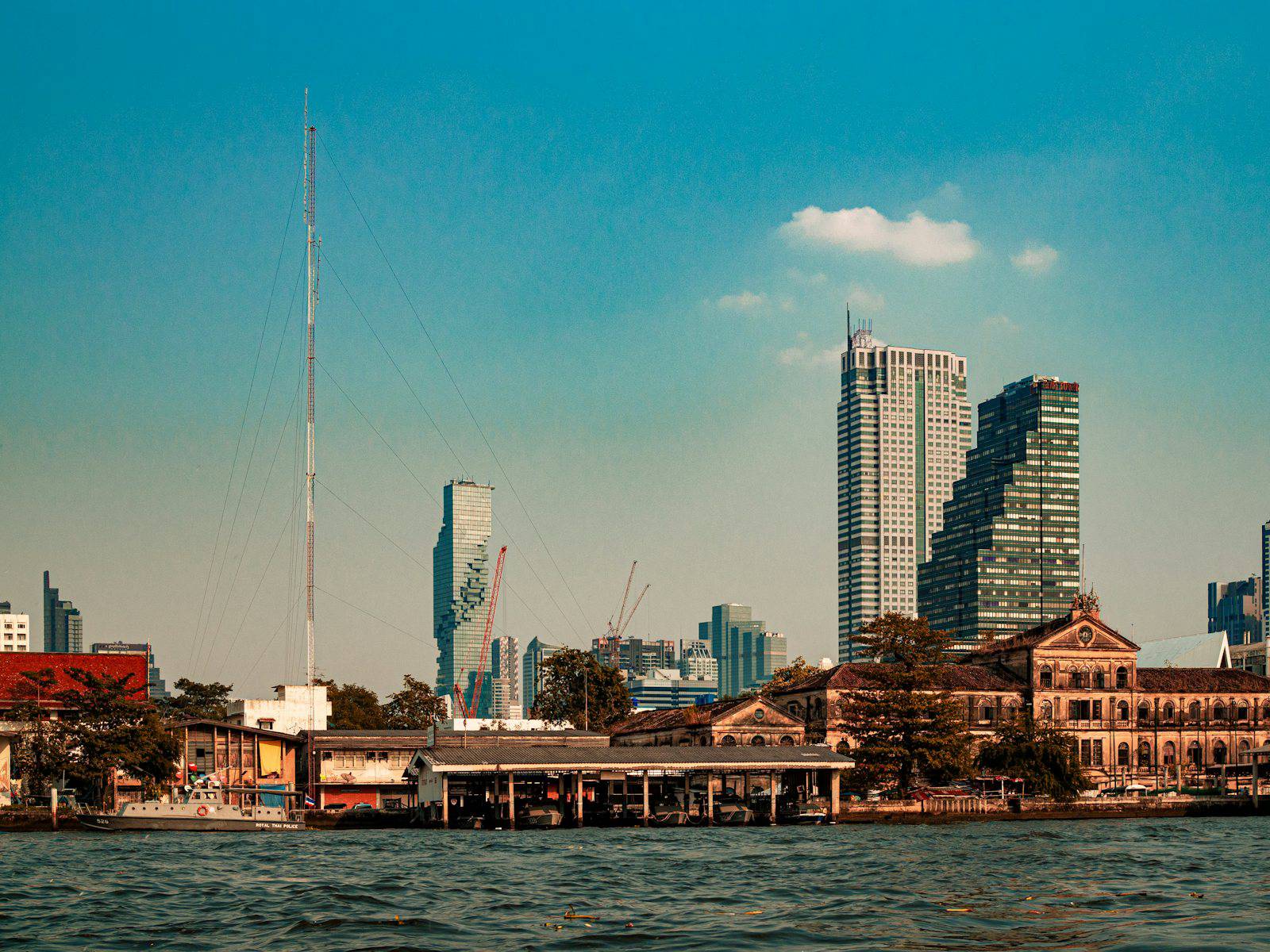Bangkok riverside under a clear blue sky