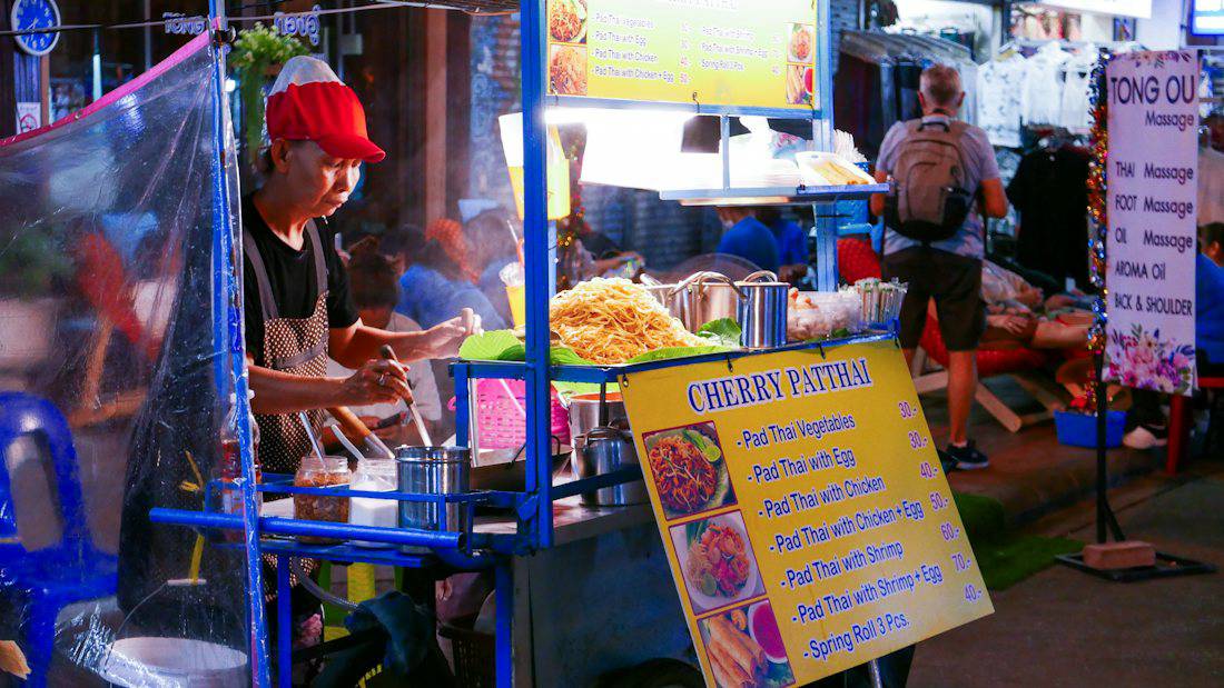 Local food stall and menu signs in Bangkok