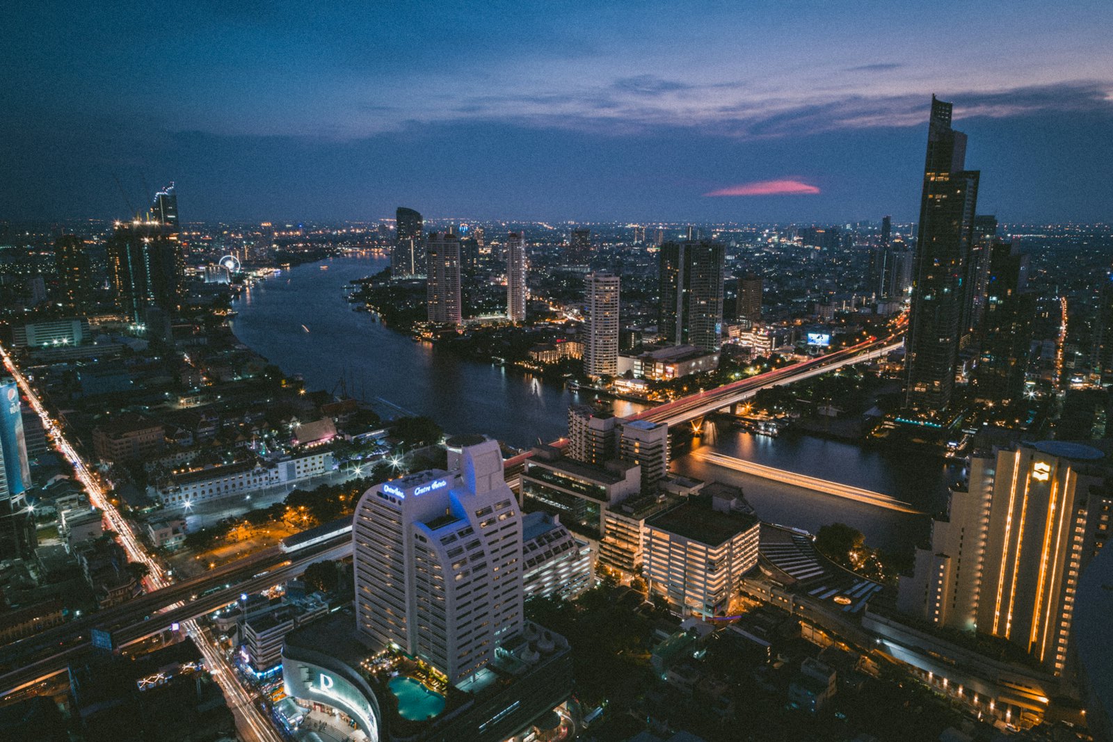 The Chao Phraya River curving through the Bangkok skyline at dusk
