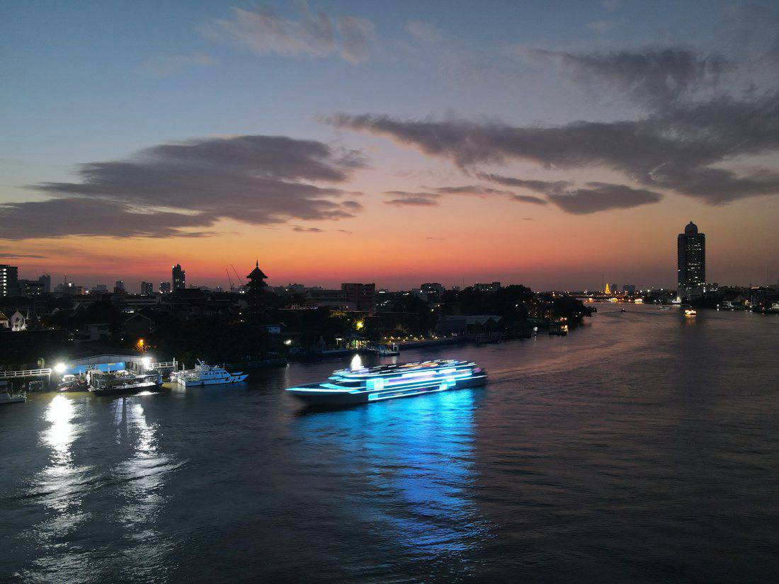 Dinner cruise boat on the Chao Phraya River at dusk