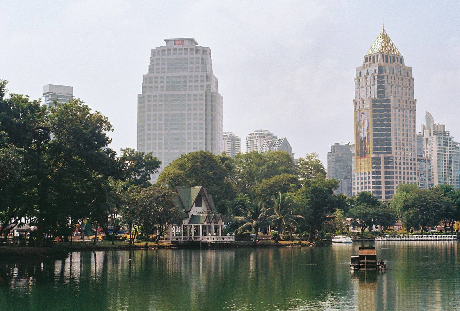 Lumpini Park lake with Silom and Sathorn towers behind