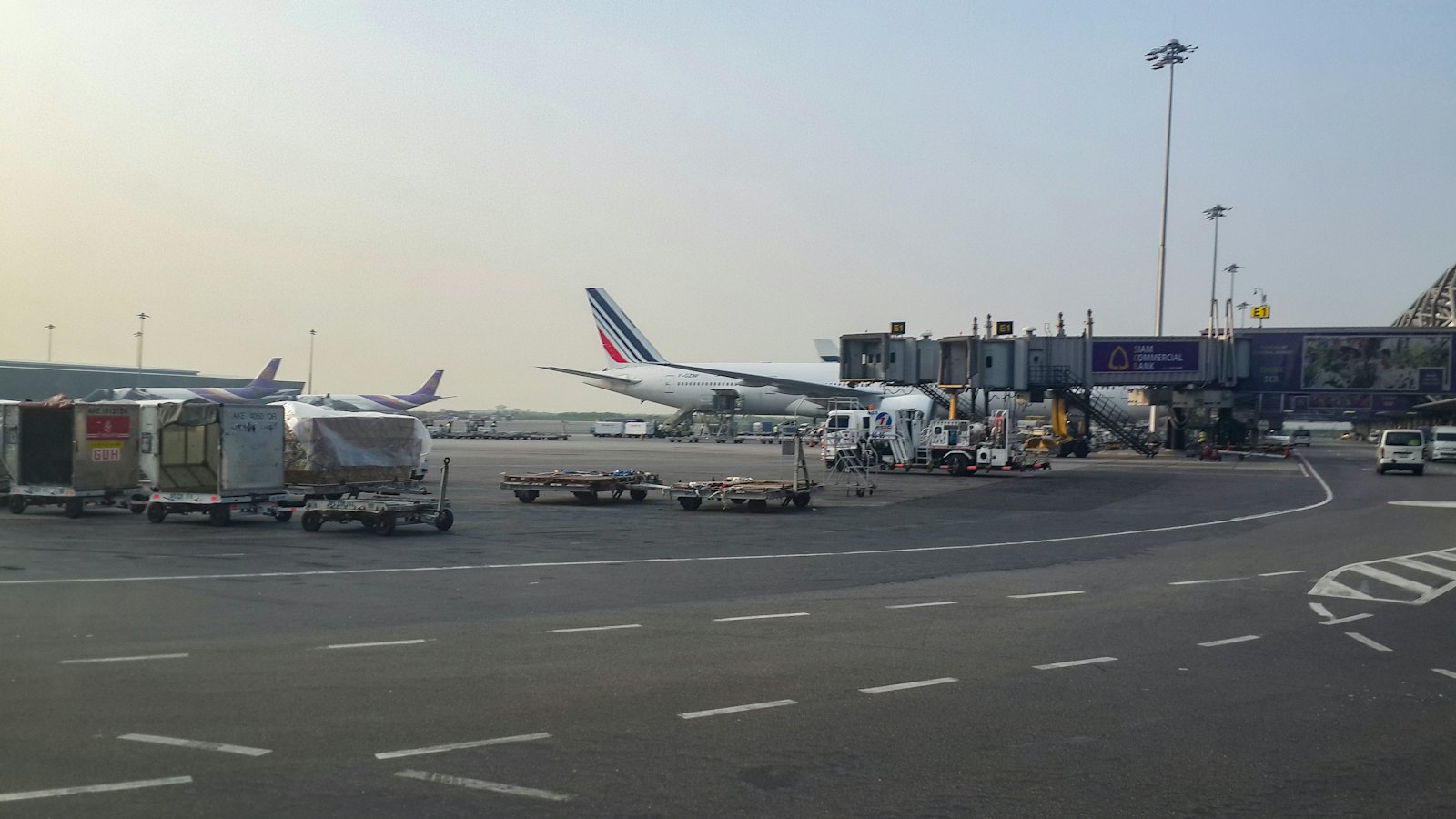 Planes parked at the gates of Suvarnabhumi Airport in Bangkok on a hazy morning