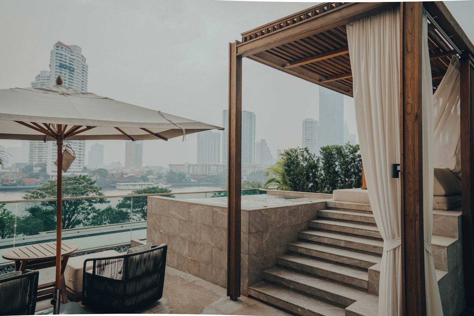 Hotel terrace with a cabana overlooking the Bangkok skyline
